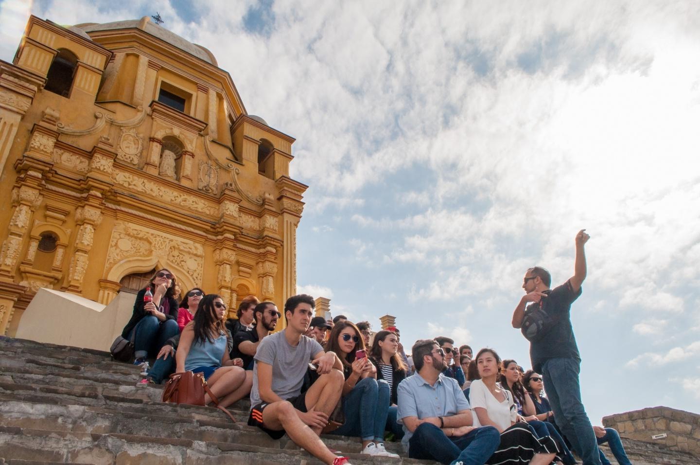 Students take part in a class on cathedral steps in Monterrey, Mexico