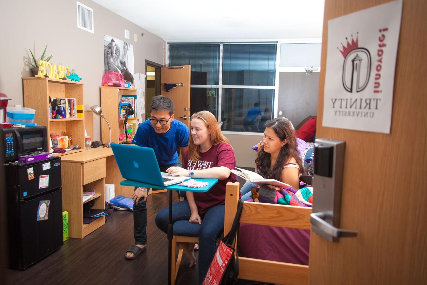 E-Hall students collaborate at desk in dorm room