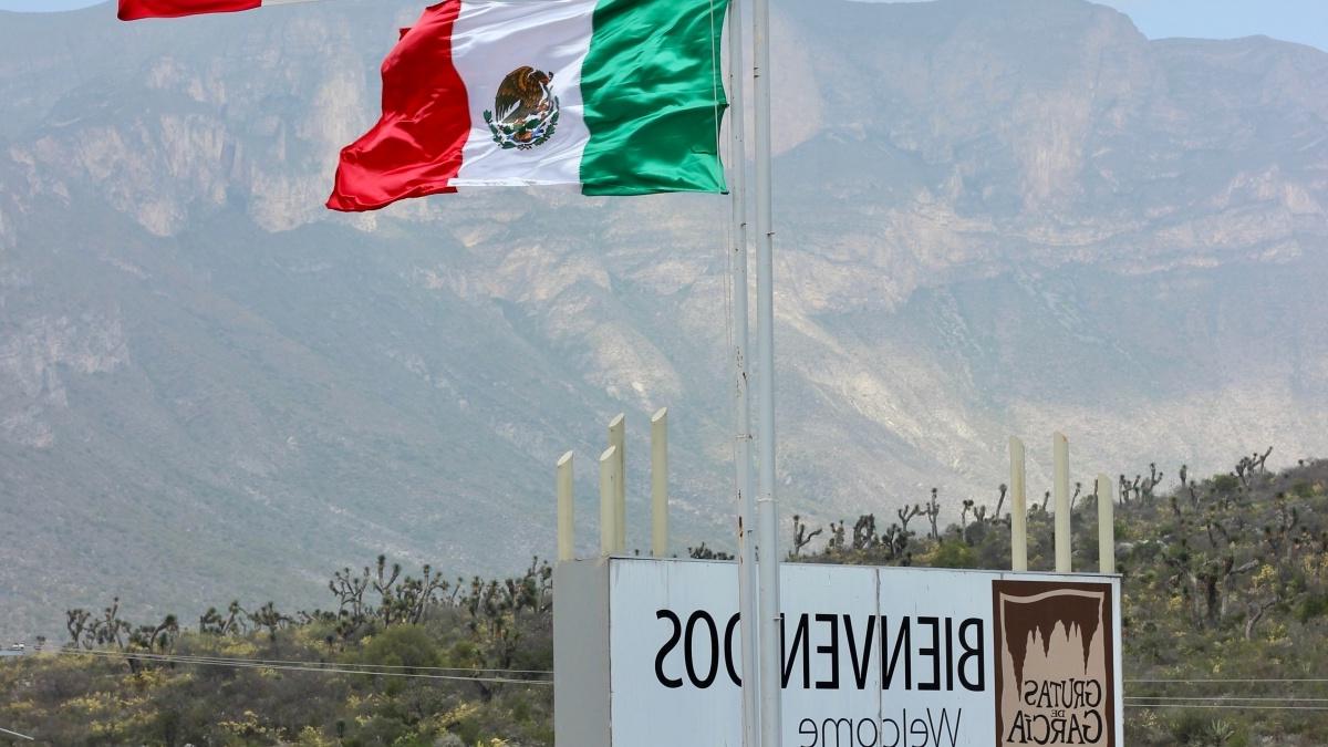 Two Mexican Flags mark the entrance to the city of nuevo leon